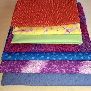 Bundle of 7  assorted fabric scraps.